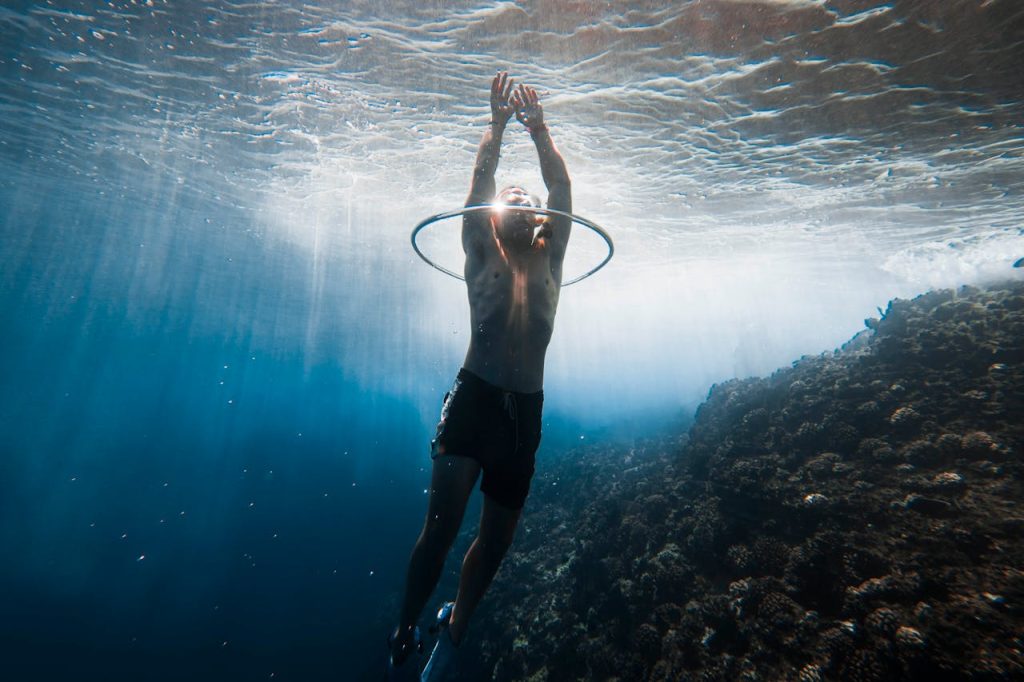 Diver Swimming through Water Ring